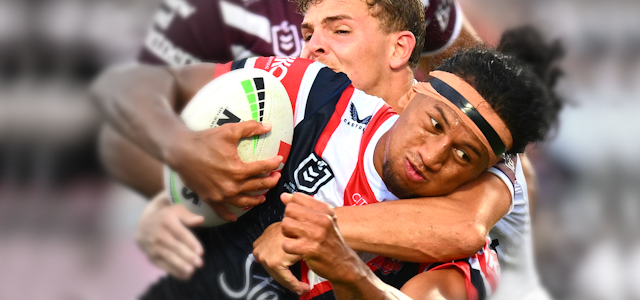 Rugby league player tackles an opponent carrying the ball