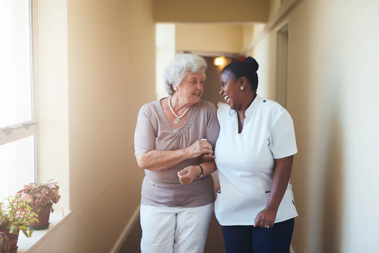 A carer and an elderly lady.