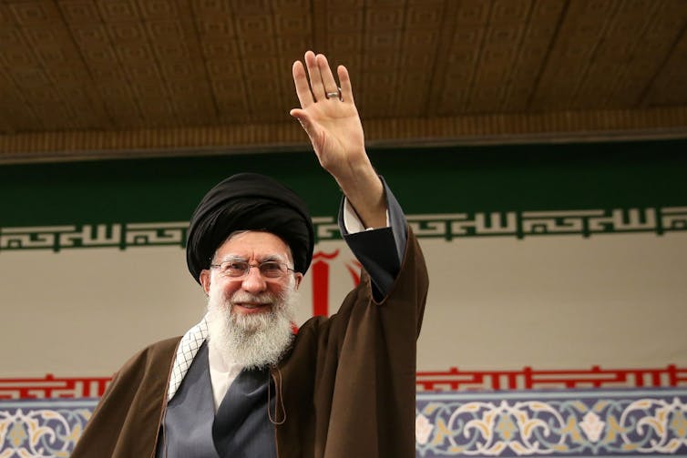 Iran's supreme leader, Ayatollah Ali Khamenei waves to supporters.