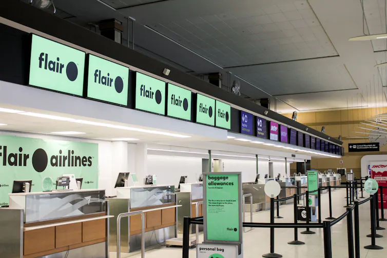 Flair Airlines check-in counters seen in an airport