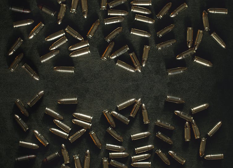 Bullets are scattered about a table top.