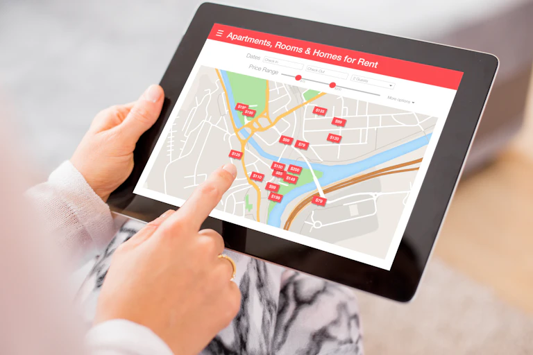 A person searches for accommodation on a tablet