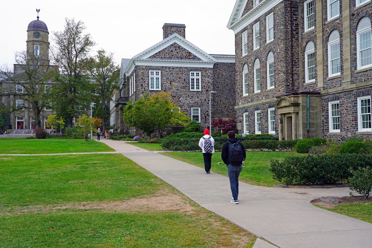 People seen walking on a campus path.