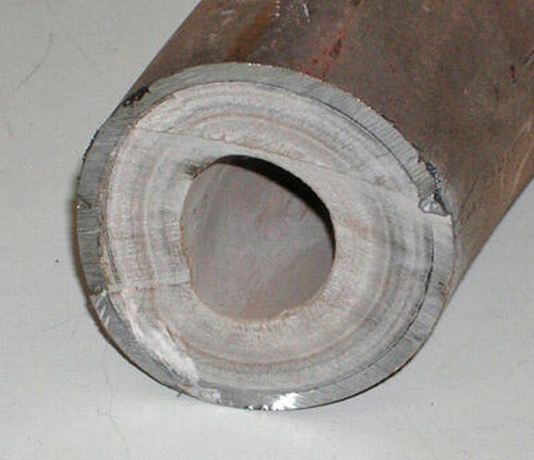 A pipe with grey material on the inside.