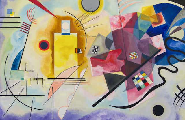 An abstract painting seen with geometric shapes floating including what looks like the side of a Rubik's cube.
