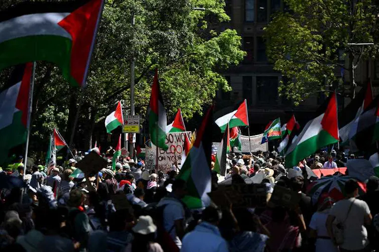 A group of protestors waving Palestinian flags