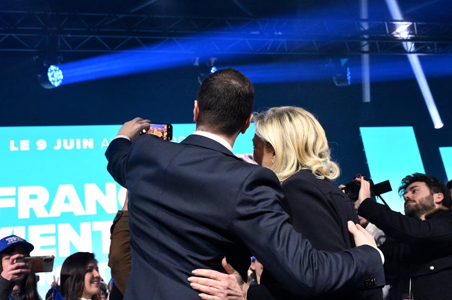 La présidente du groupe d'extrême droite du Rassemblement national (RN) à l'Assemblée nationale, Marine Le Pen, et le président du RN et chef de file de la liste électorale, Jordan Bardella, posent pour un selfie sur scène à la fin d'un meeting visant à lancer la campagne du RN pour les prochaines élections européennes, à Marseille, le 3 mars 2024.
