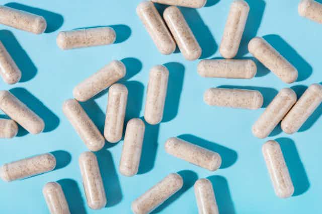 Supplement capsules on a blue background