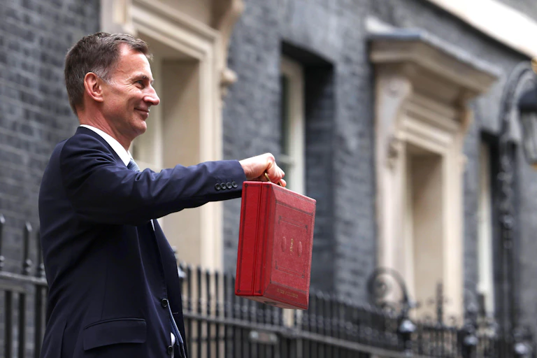 Jeremy Hunt holding up the red briefcase