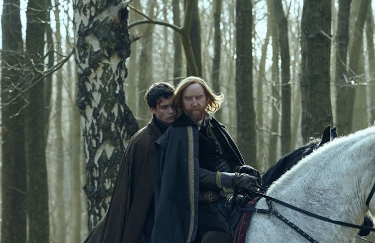 Nicholas Galitzine as George Villiers and Tony Curran as King James, both riding on a white horse.