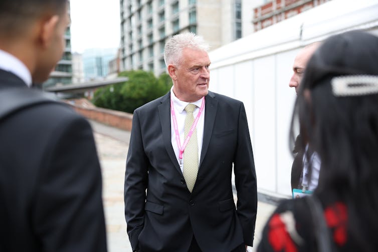 Lee Anderson talking to a group of people outside a venue at Conservative party conference.