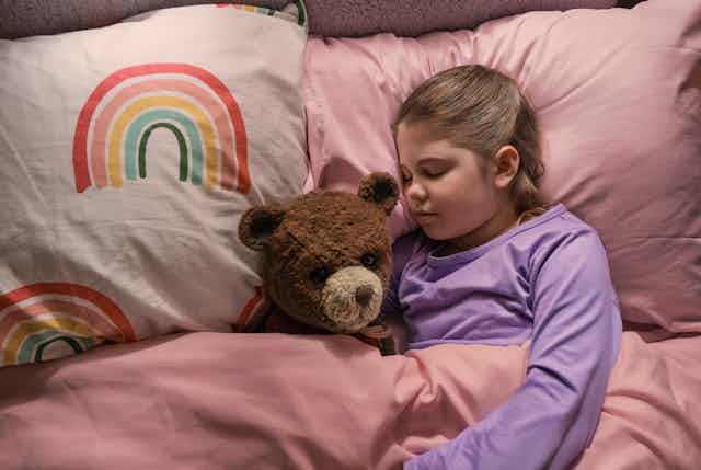 Pyper Braun as Alice with Chauncey the bear in bed.