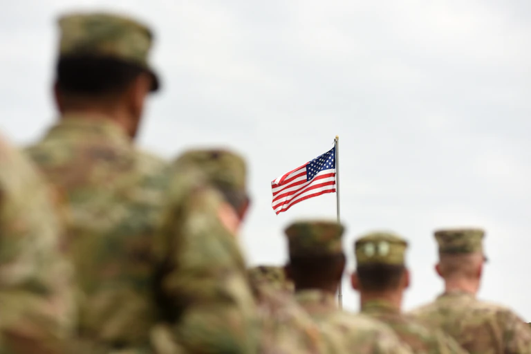 American soldiers in the foreground of the US Flag
