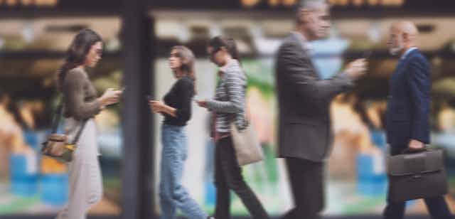 Blurry image of several people shopping