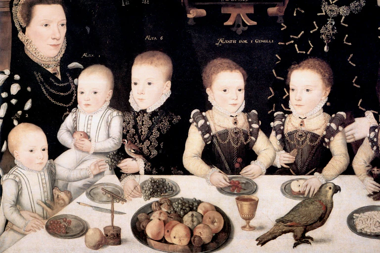 A Tudor painting of a family sitting around the dinner table