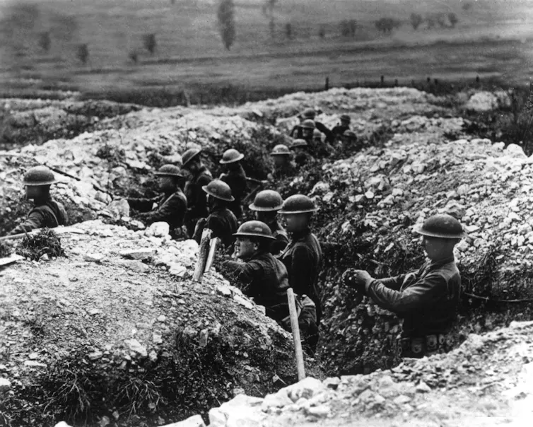 A black and white photo of soldiers in a trench