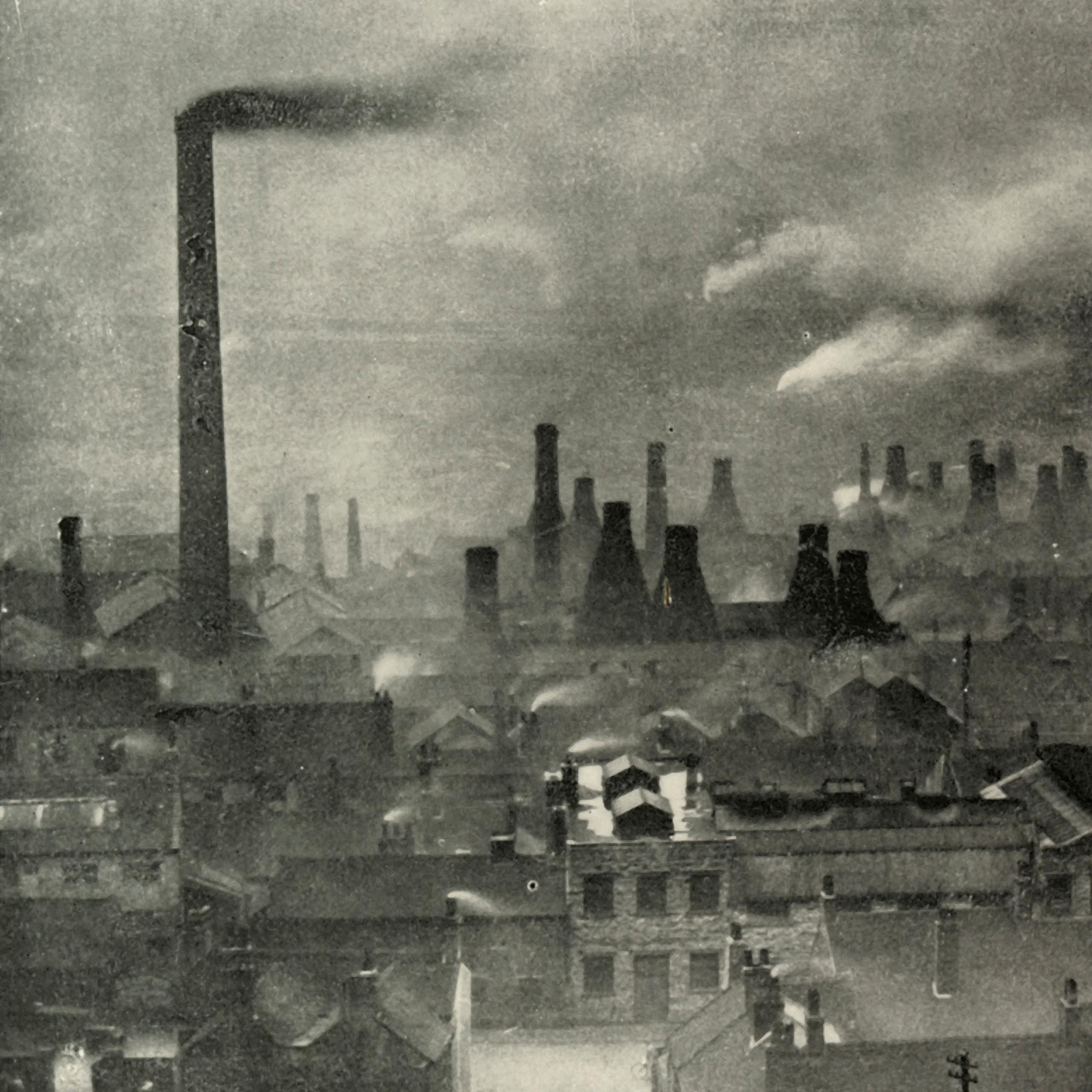 Smoke rises from many chimneys in an industrial area of England.