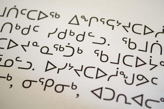 Inuktitut syllabics seen on a page in a book