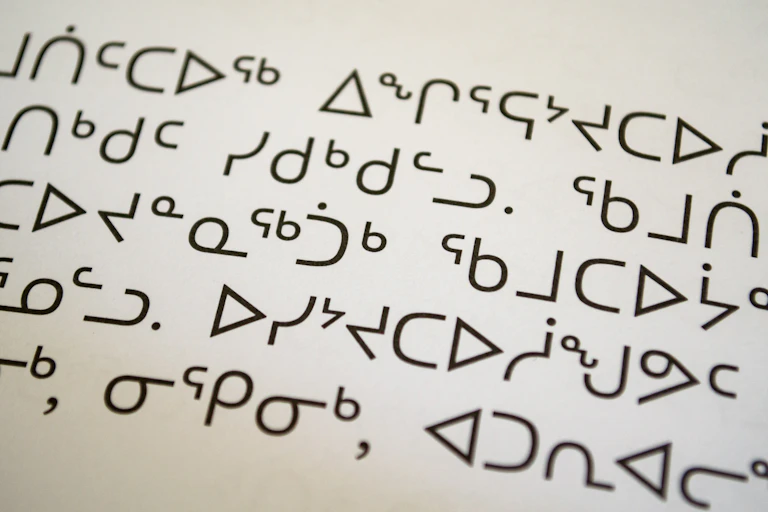 Inuktitut syllabics seen on a page in a book