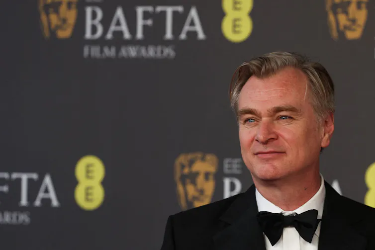 Middle-aged man in a tuxedo and at an awards ceremony.
