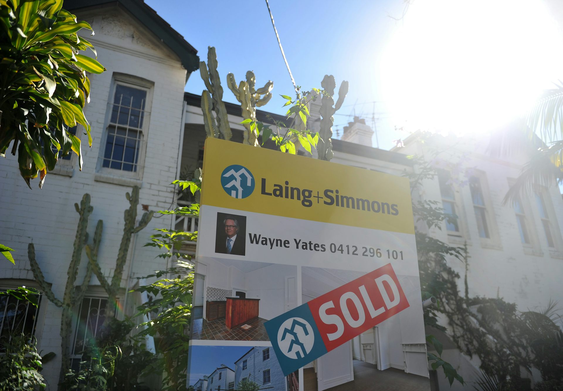 large home with sold sign out front