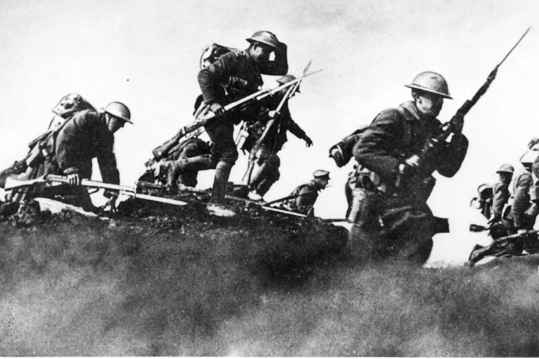 A black and white photo of world war 1 soldiers in uniform carrying rifles