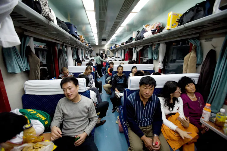 People sitting on a train in China.