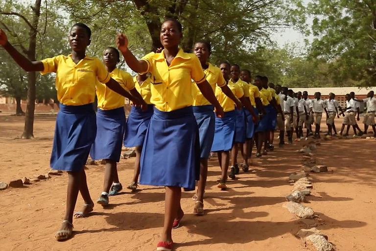 A group of girls in yellow marching