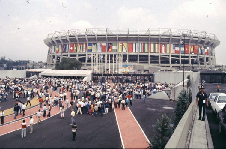 An image of a crowd gathered outside a large football stadium.