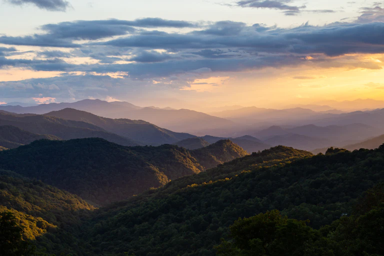 Mountains and clouds with a faint hint of the sun.