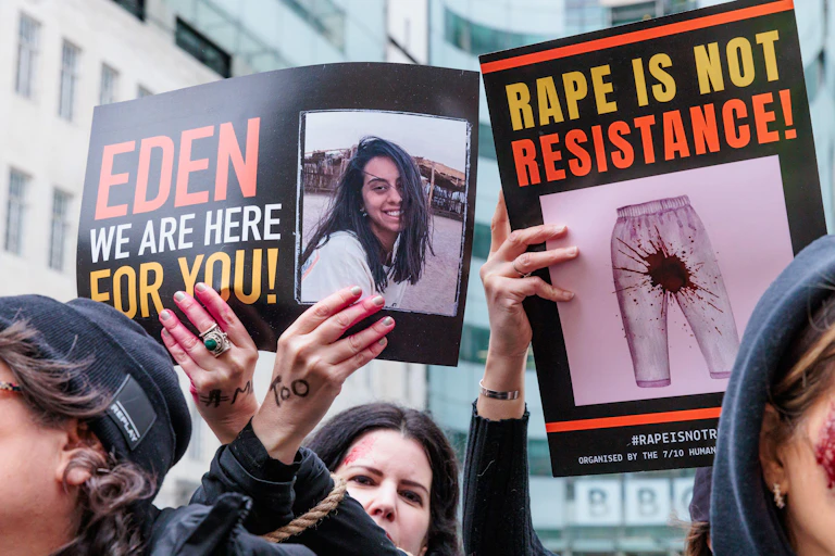 Pro-Israel demonstrators hold up signs denouncing sexual violence allegedly committed by Hamas on October 7.