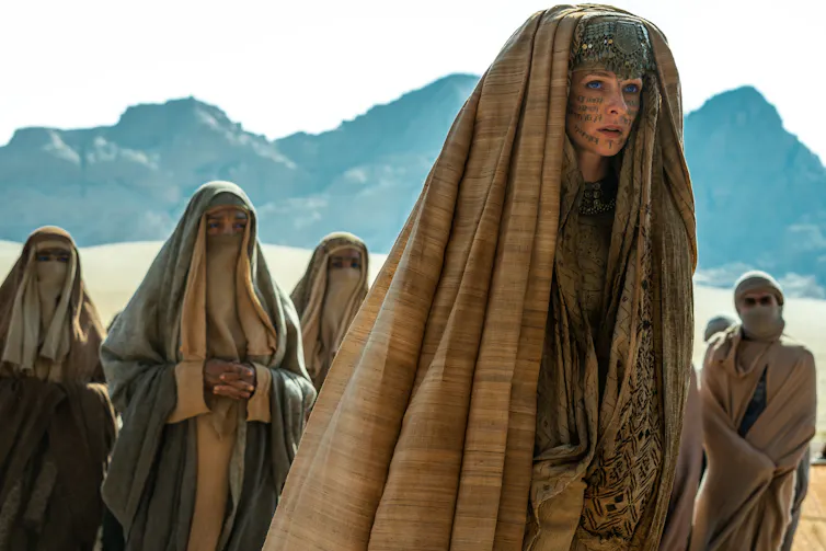 People in head scarves in desert