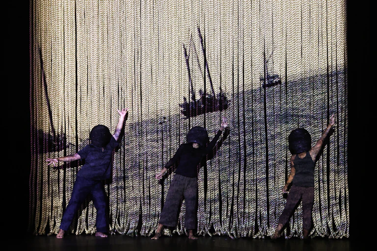 Marrugeku's Mutiara, three dancers on stage