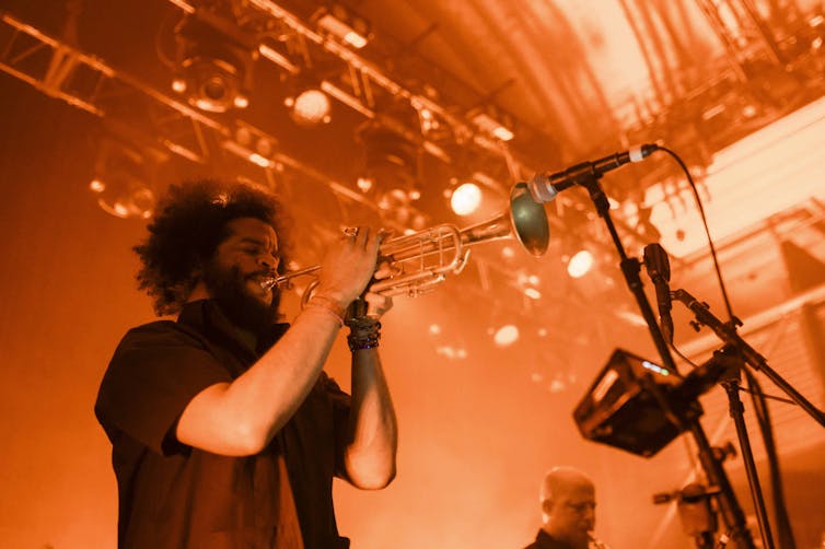 A man plays a trumpet.