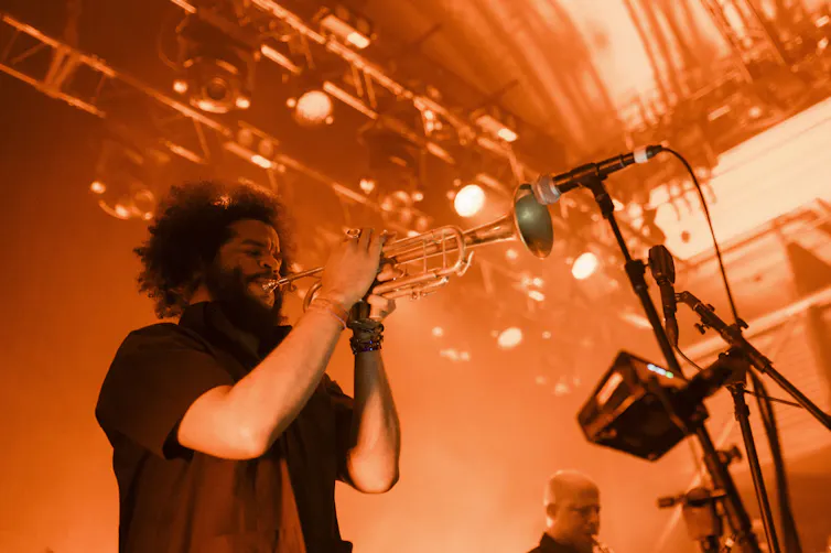 A man plays a trumpet.