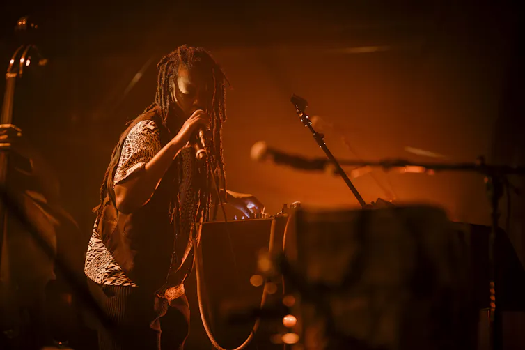 A woman sings.