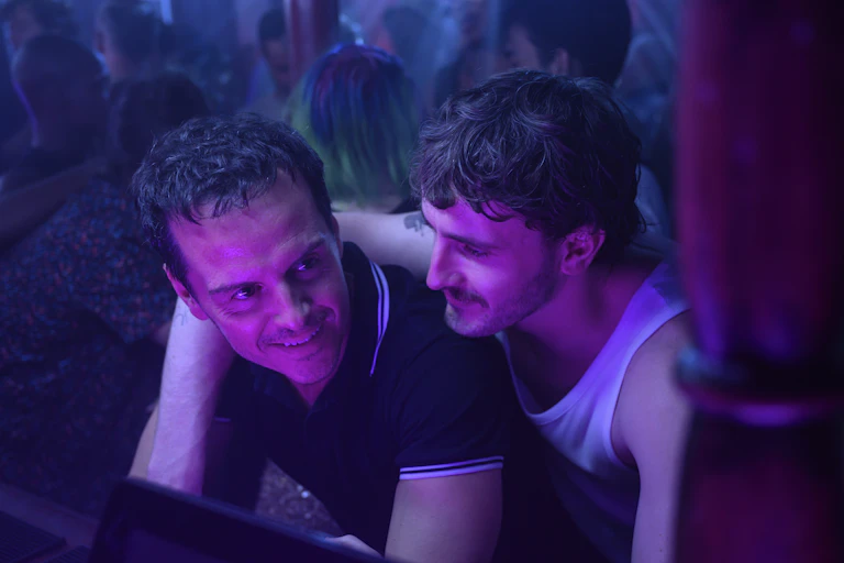 Two men embrace at a club