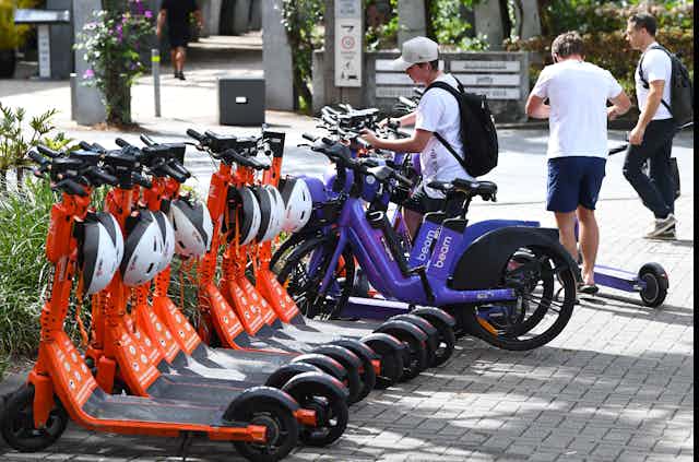 Rows of parked e-scooters and e-bikes in Brisbane city centre