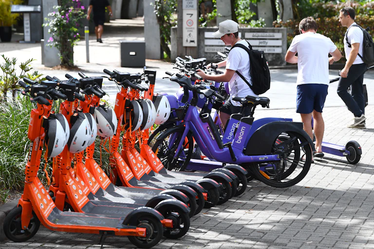 Rows of parked e-scooters and e-bikes in Brisbane city centre