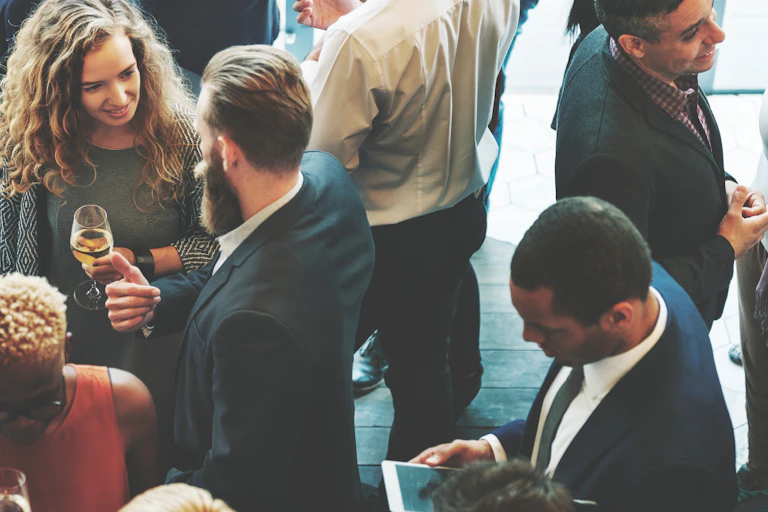 A group of workers interact in an event outside the office.