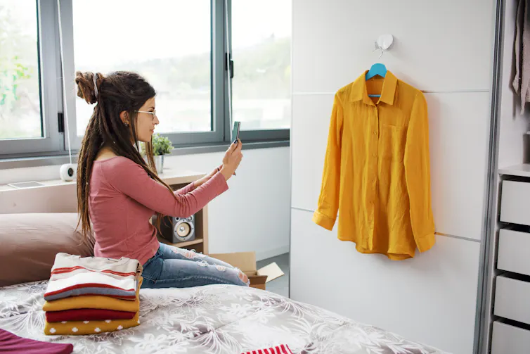 woman takes photo of shirt