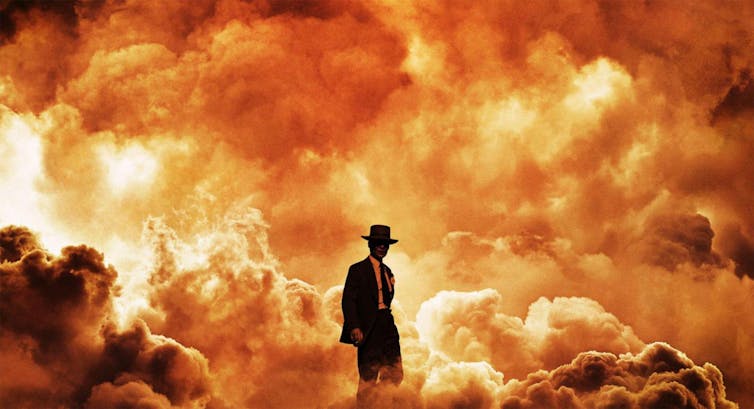 A man walking against a background of fire and smoke.