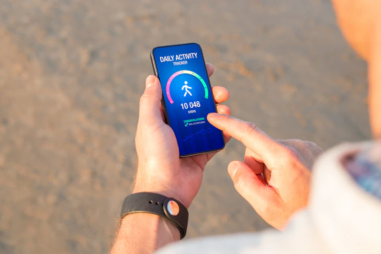 Person looking at an activity tracking app on a smartphone