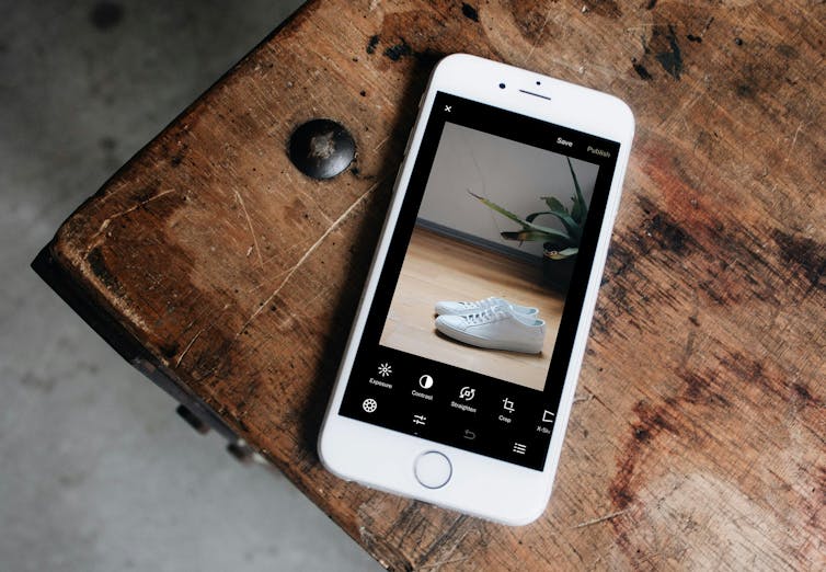 A smartphone with a picture of sneakers on the screen