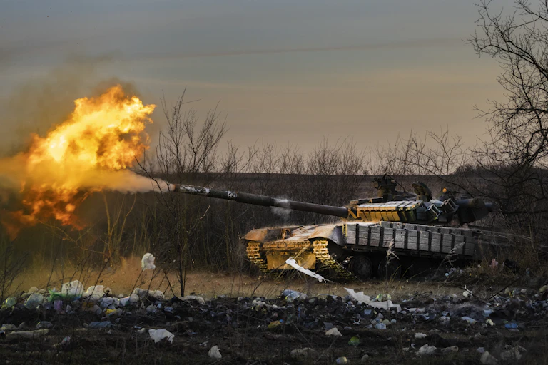 A fire ball erupts as a tank fires a shell