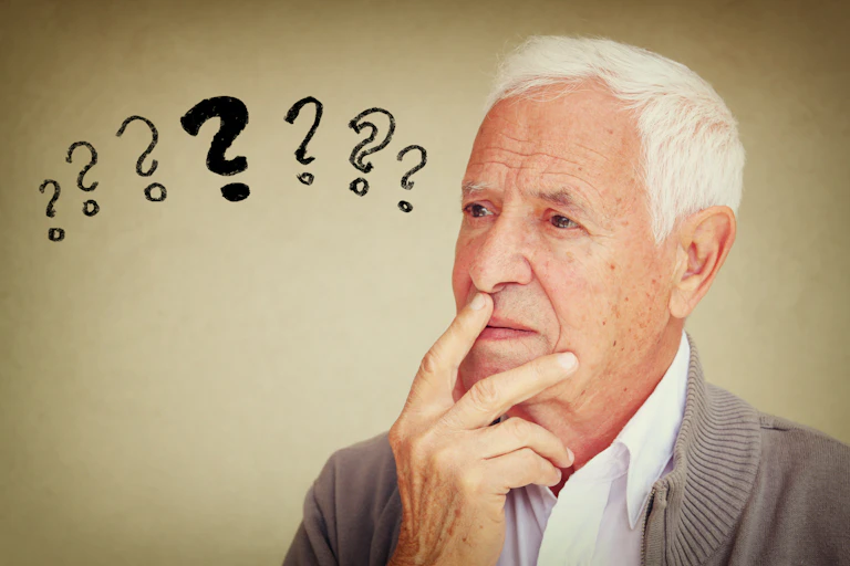 Older man with question marks next to his head