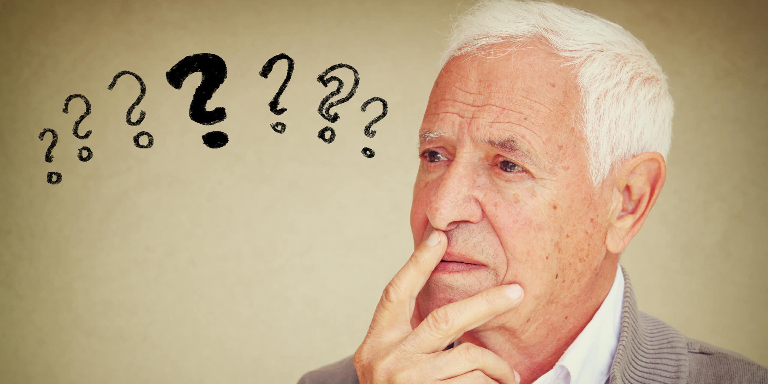 Older man with question marks next to his head