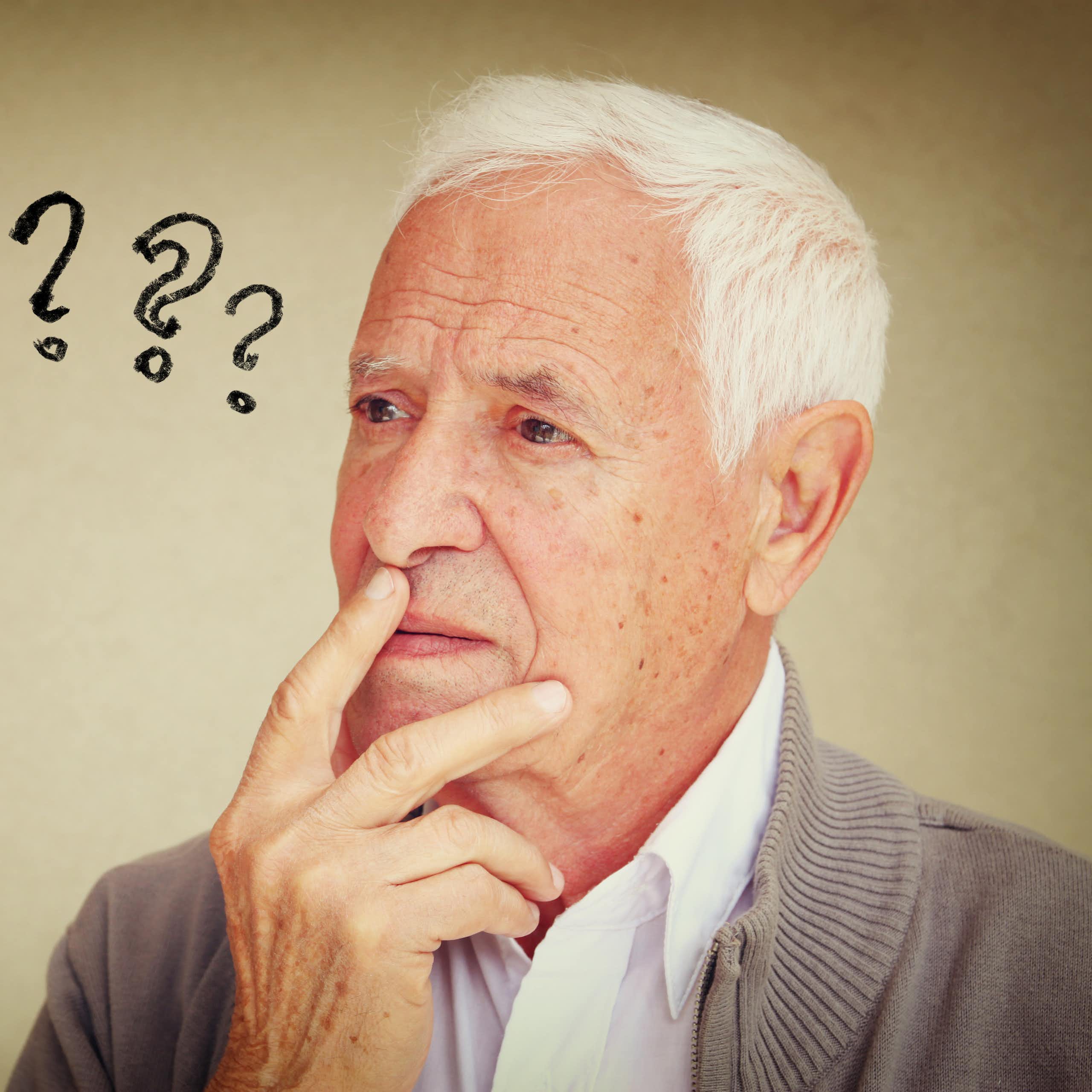Older man with question marks next to his head