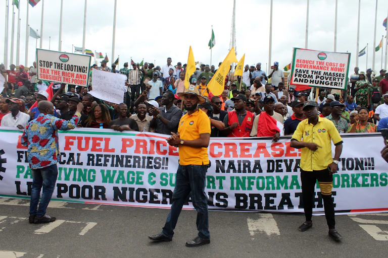People holding banners and placards while marching on the street