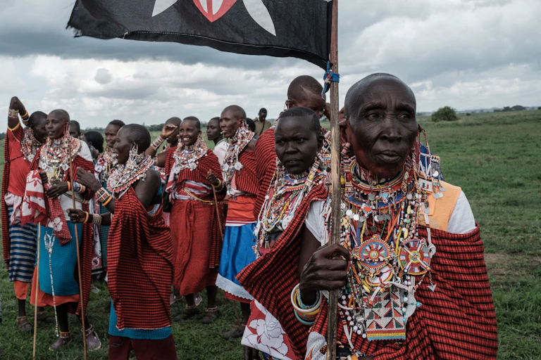 A group of Maasai women, with one holding a Kenyan flag